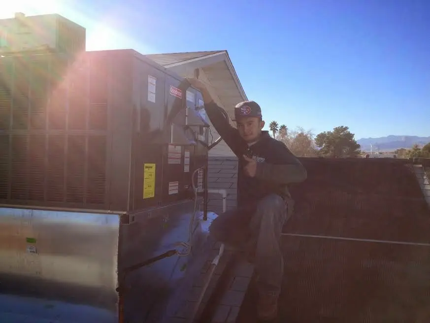 HVAC technician performing HVAC Inspection on a rooftop unit in Grant-Valkaria